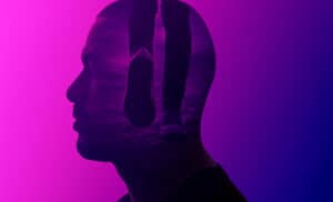 Double-exposure profile of a person with a walking figure inside, representing the mind-body connection.