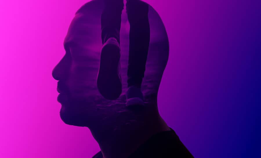 Double-exposure profile of a person with a walking figure inside, representing the mind-body connection.